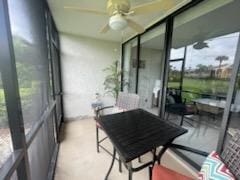 sunroom featuring a ceiling fan