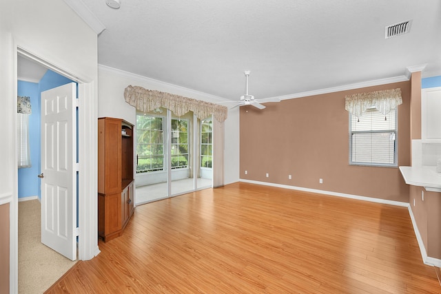 unfurnished living room with ceiling fan, ornamental molding, and light hardwood / wood-style floors