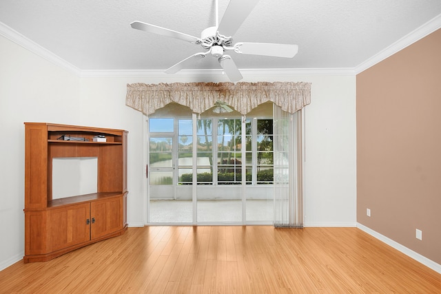 unfurnished room featuring ceiling fan, ornamental molding, a textured ceiling, and light wood-type flooring