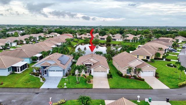 aerial view of residential area with a large body of water