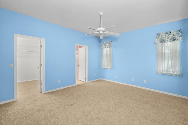 unfurnished room with ceiling fan and light carpet