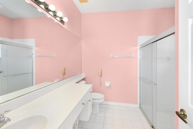 bathroom featuring tile patterned flooring, toilet, vanity, and a shower with shower door