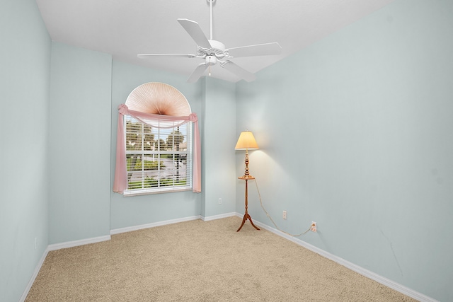 carpeted spare room with ceiling fan