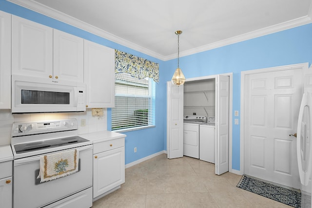 kitchen with pendant lighting, white appliances, backsplash, and white cabinets