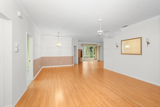 interior space with ornamental molding, ceiling fan with notable chandelier, and light hardwood / wood-style flooring