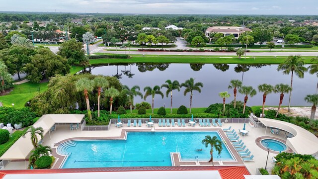 view of swimming pool featuring a water view and a patio