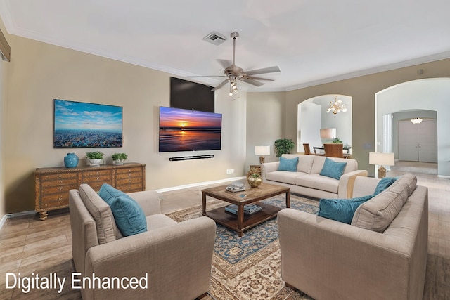 living room featuring ceiling fan with notable chandelier, light hardwood / wood-style floors, and ornamental molding