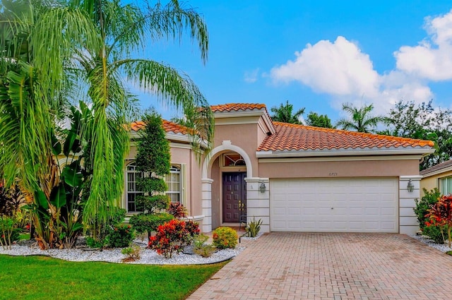 mediterranean / spanish home featuring a garage