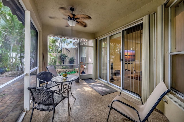 sunroom / solarium featuring ceiling fan