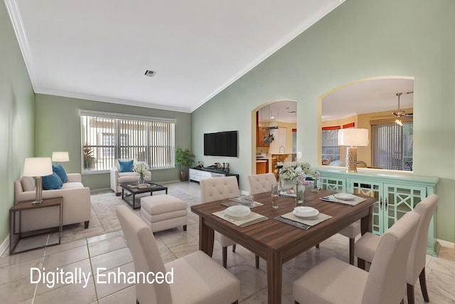 tiled dining area featuring ceiling fan, high vaulted ceiling, and ornamental molding