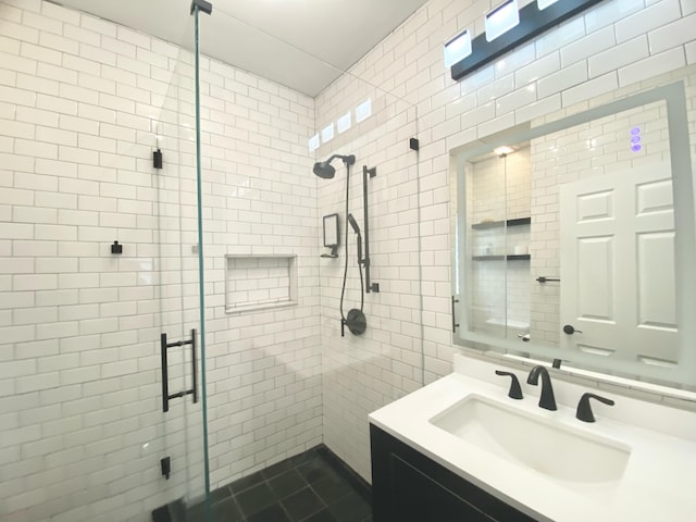 bathroom featuring tile walls, vanity, and an enclosed shower