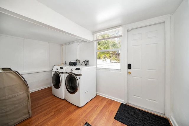 clothes washing area featuring light wood-type flooring and washing machine and dryer