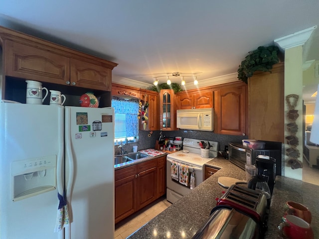 kitchen featuring crown molding, white appliances, light tile patterned flooring, and sink