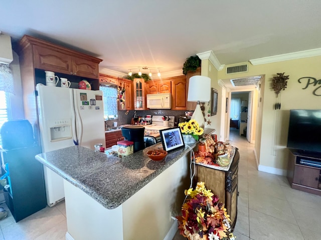 kitchen featuring backsplash, white appliances, crown molding, and a wealth of natural light