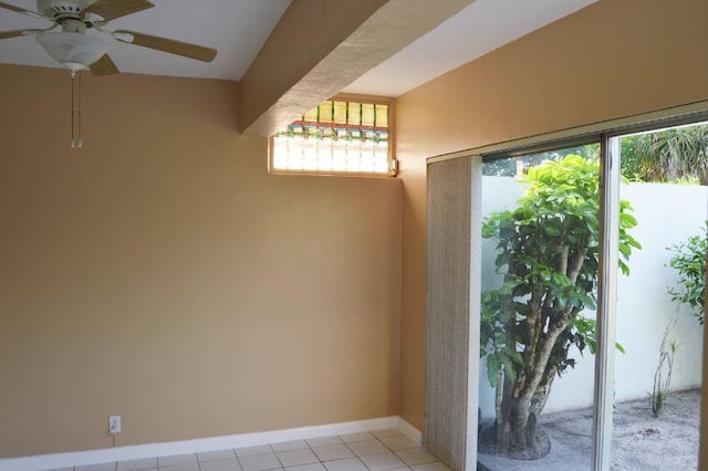 tiled empty room with ceiling fan