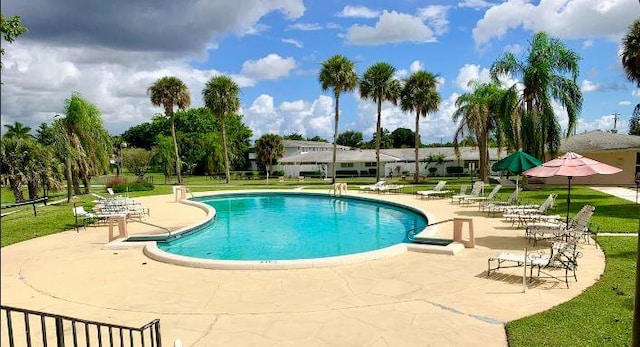 view of pool with a yard and a patio area