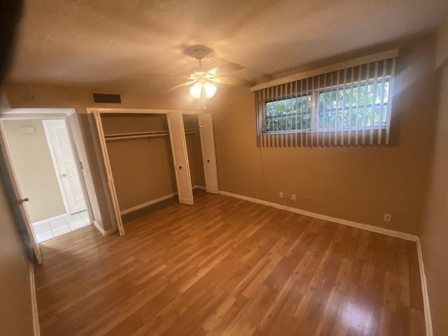 unfurnished bedroom featuring ceiling fan and hardwood / wood-style floors