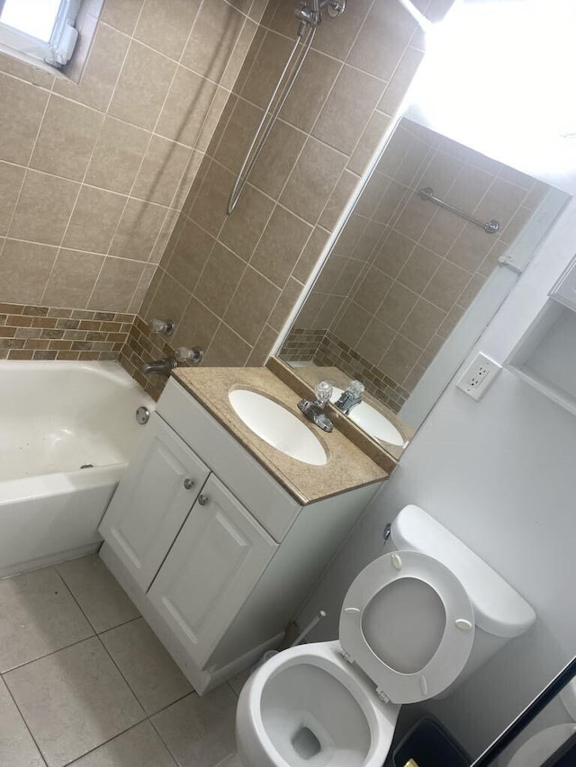 full bathroom with vanity, tile patterned floors, tiled shower / bath, and toilet