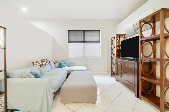 tiled living room with lofted ceiling