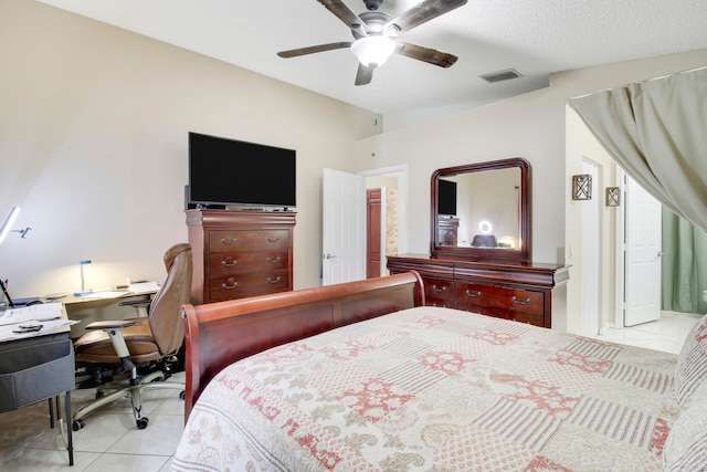 tiled bedroom with ceiling fan and a textured ceiling