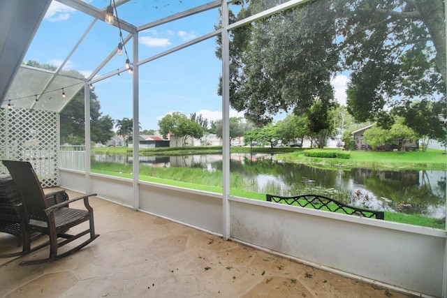 unfurnished sunroom with a water view