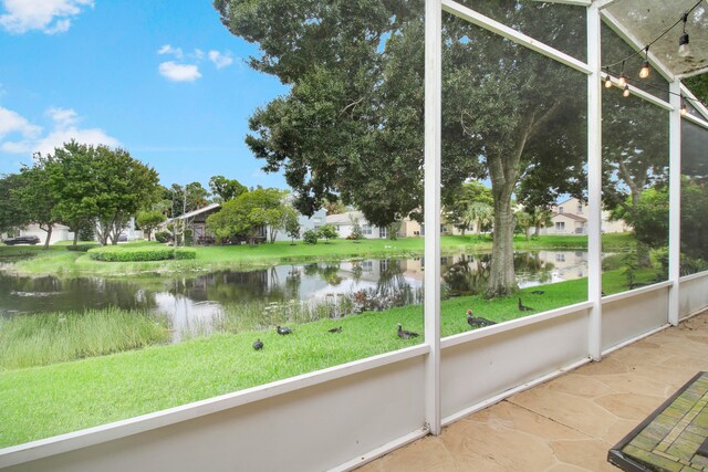 unfurnished sunroom with a water view