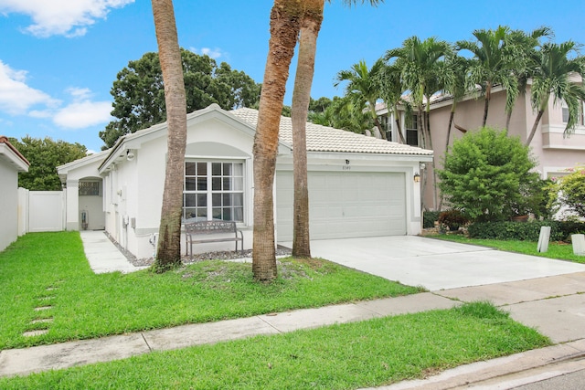 view of front of house featuring a front yard and a garage