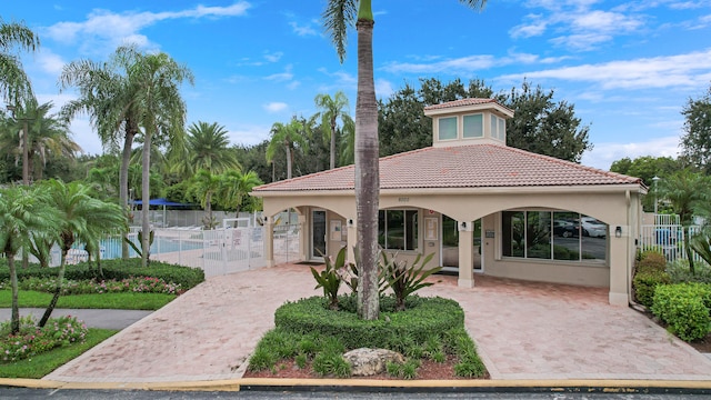 mediterranean / spanish-style home featuring a community pool