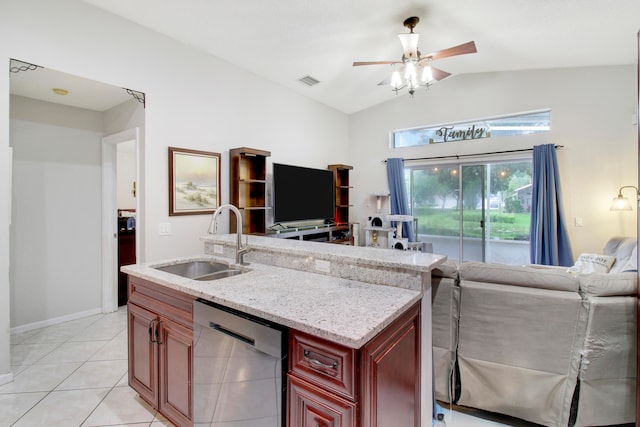 kitchen with vaulted ceiling, sink, stainless steel dishwasher, light stone countertops, and light tile patterned floors