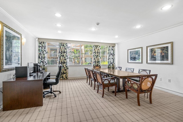 dining room with a healthy amount of sunlight, ornamental molding, and light colored carpet