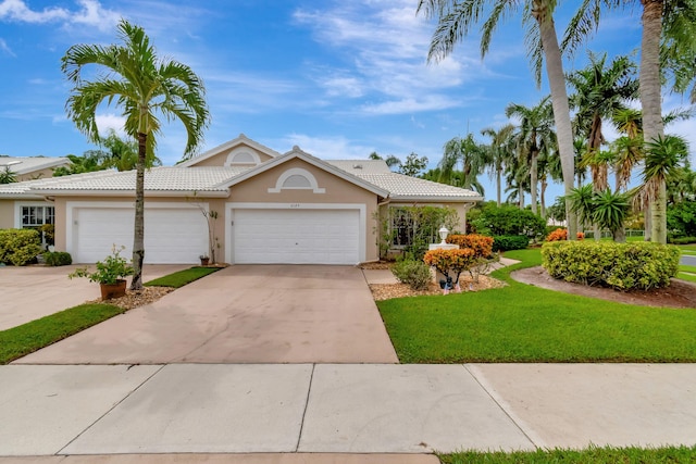 view of front of house with a front yard and a garage