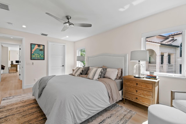 bedroom with ceiling fan and light hardwood / wood-style flooring