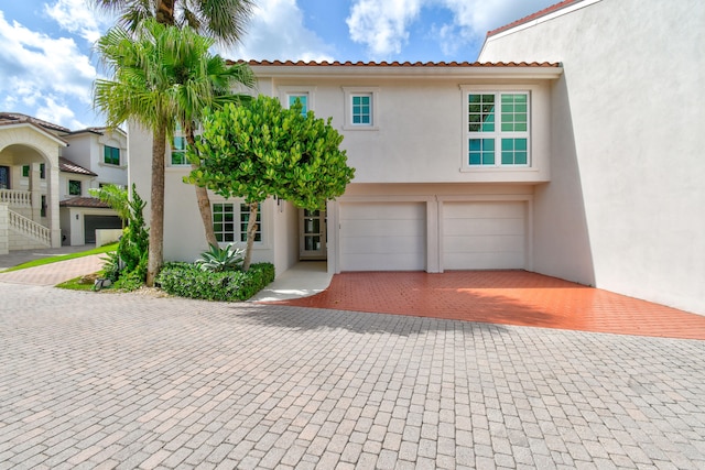 mediterranean / spanish-style home featuring a garage