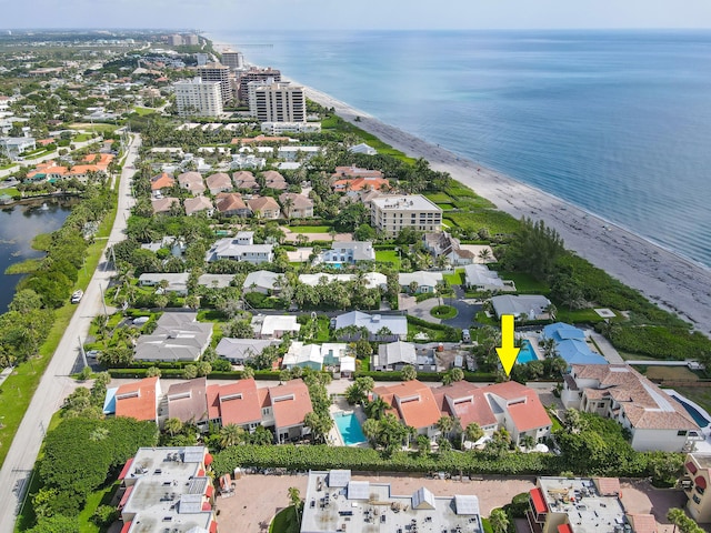 birds eye view of property featuring a water view and a view of the beach