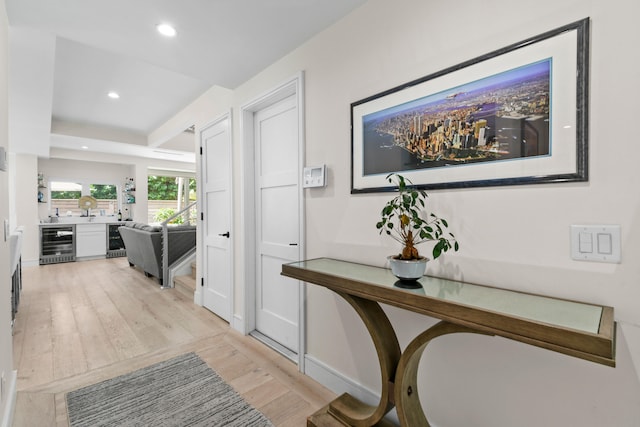 hallway featuring light hardwood / wood-style flooring and beverage cooler