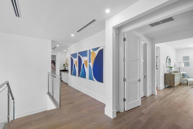 hallway with hardwood / wood-style flooring