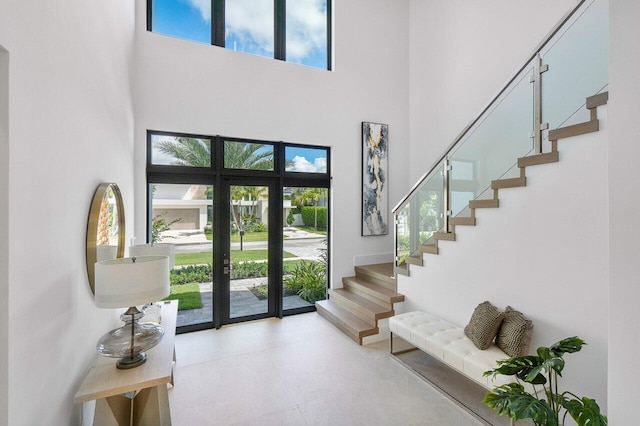 foyer entrance featuring a towering ceiling