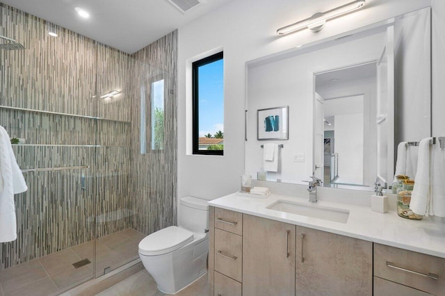 bathroom featuring tile patterned flooring, vanity, toilet, and a shower with door