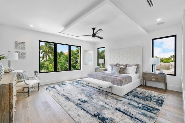 bedroom with light hardwood / wood-style floors and ceiling fan