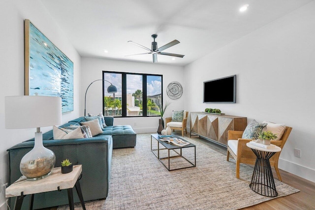 living room with wood-type flooring and ceiling fan