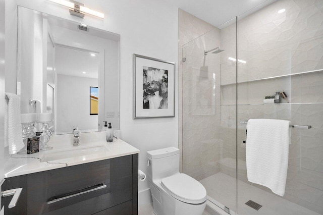 bathroom featuring an enclosed shower, vanity, and toilet