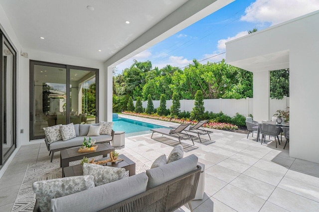 view of patio with outdoor lounge area and a fenced in pool