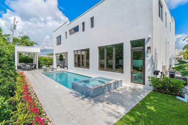 view of swimming pool featuring a patio, an in ground hot tub, a lawn, and central AC unit