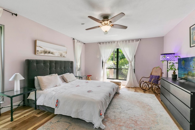 bedroom with ceiling fan and hardwood / wood-style floors