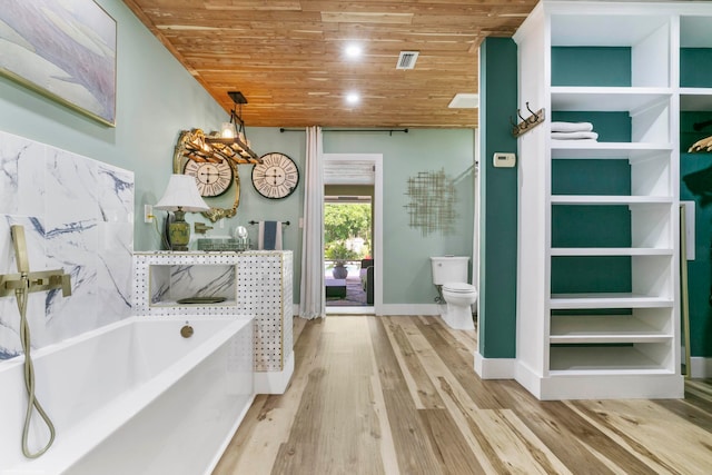 bathroom featuring wood ceiling, wood-type flooring, a bathtub, and toilet