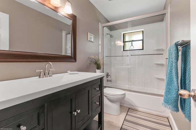 full bathroom with tiled shower / bath combo, tile patterned flooring, vanity, and toilet