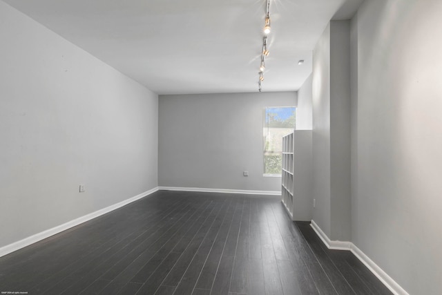 unfurnished room with dark wood-type flooring