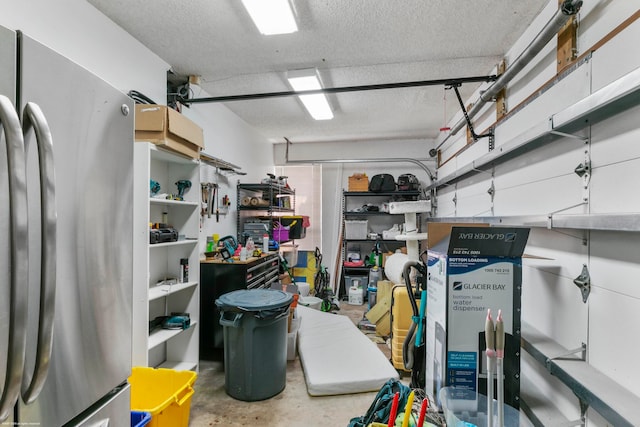 garage with stainless steel fridge