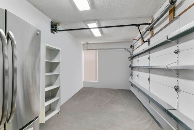 garage with stainless steel refrigerator