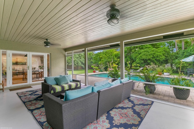 sunroom / solarium featuring ceiling fan and wooden ceiling